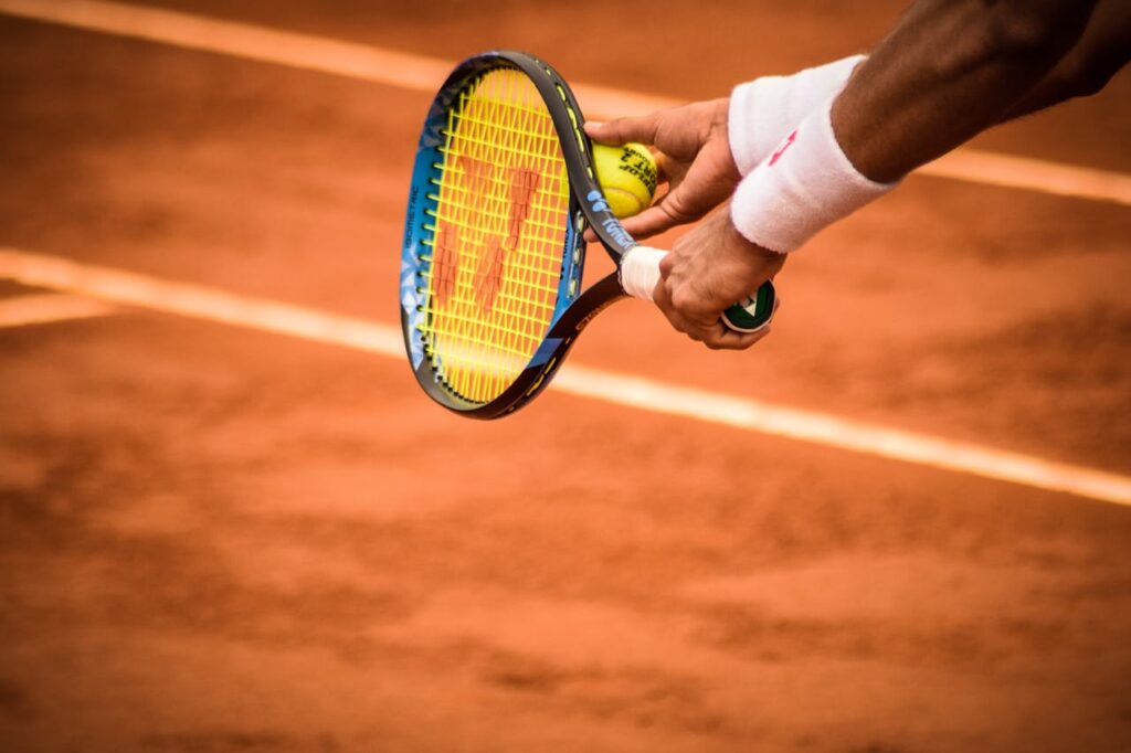 pexels-photo-1432039 Close-up of a tennis player preparing to serve on a clay court in Montevideo.